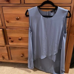 BCBG light powder blue shirt in front , long in back shift on top .